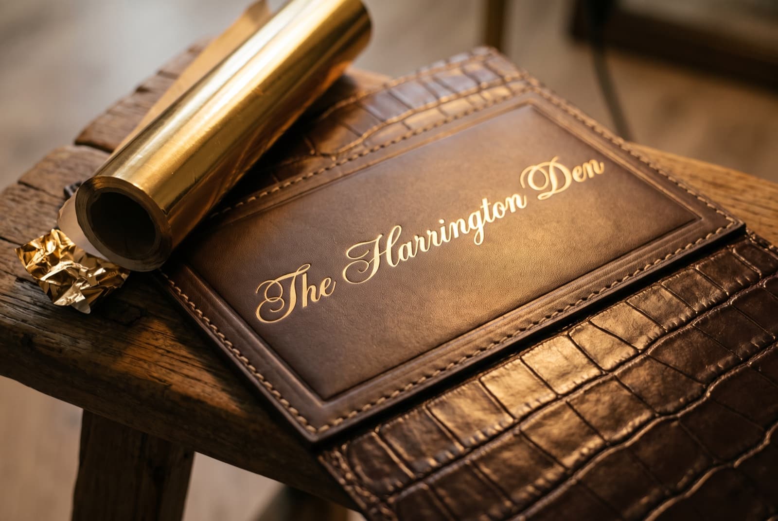 A family name pressed in flowing gold script on the leather plate