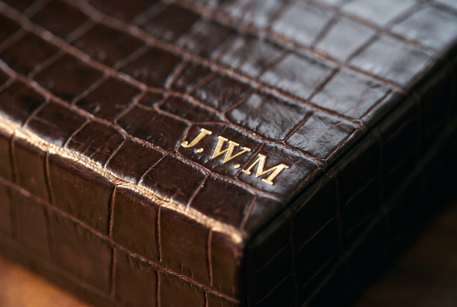 Gold initials pressed into the corner of the lid
